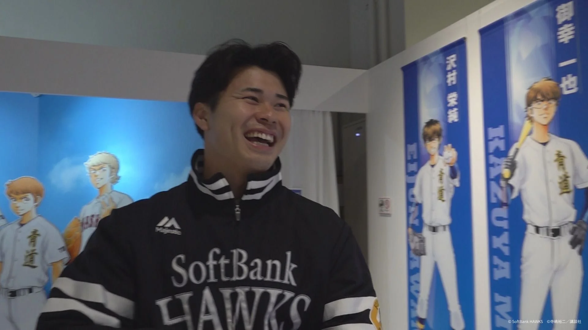 笑顔で展示を見る松本晴投手