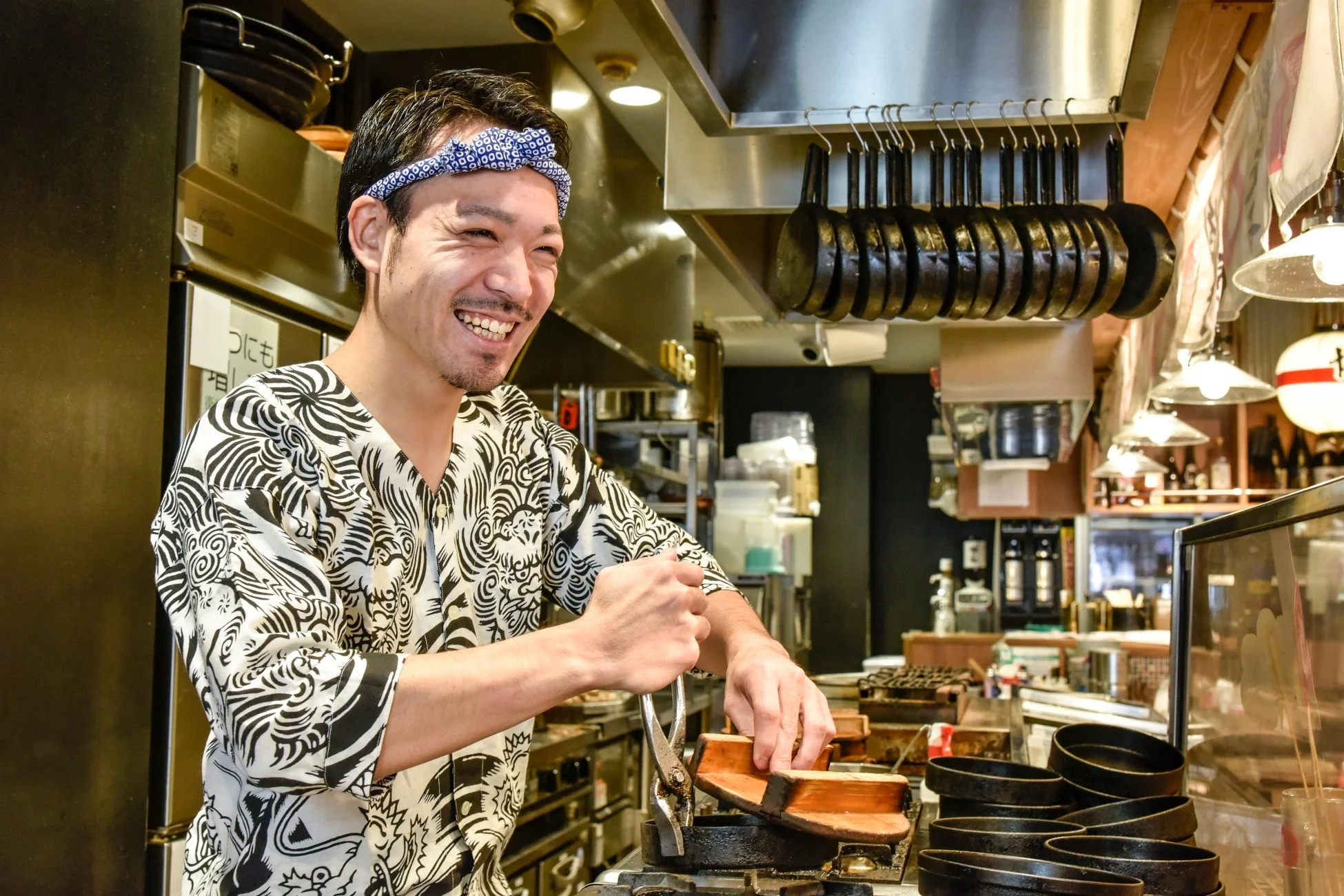 厨房で笑顔で作業する男性スタッフ