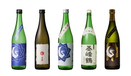 異なるデザインの日本酒「基峰鶴」のボトルが5本並べられています。緑色や茶色の瓶に、それぞれ特徴的なラベルが貼られており、商品ラインナップが示されています。